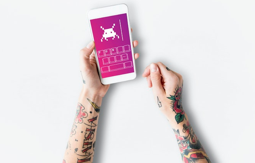 tatooed arm holding a phone
